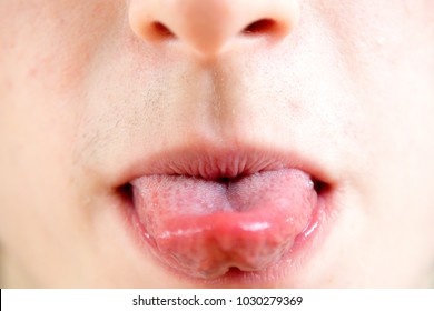 Close up of a teenage boy sticking out his tounge