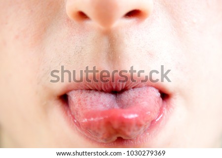 Close up of a teenage boy sticking out his tounge