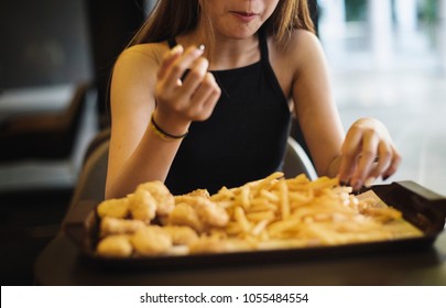 Close Up Of Teenage Girl Eating French Fries Obesity Concept