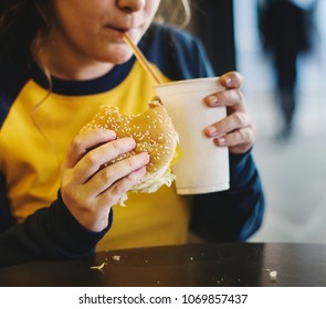 Close Up Of Teenage Girl Eating Hamburger Obesity Concept