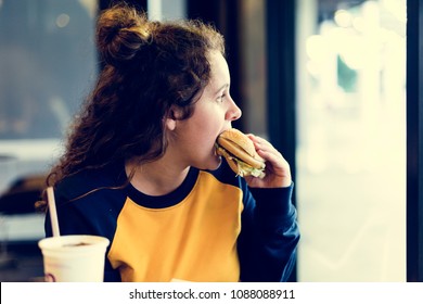 Close Up Of Teenage Girl Eating Hamburger Obesity Concept