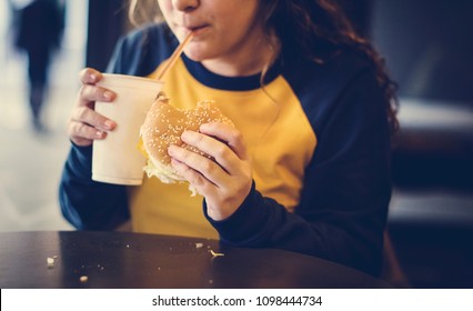 Close Up Of Teenage Girl Eating Hamburger Obesity Concept