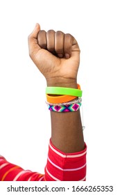 Close Up Of Teenage Girl Wearing Wristbands Raising Arm In Air To Depict Empowerment