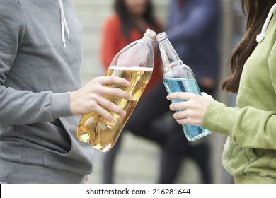 Close Up Of Teenage Group Drinking Alcohol Together