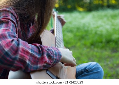 Close Up Teenager Girl Plays Guitar Outside, Country Style