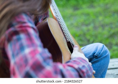 Close Up Teenager Girl Plays Guitar Outside, Country Style