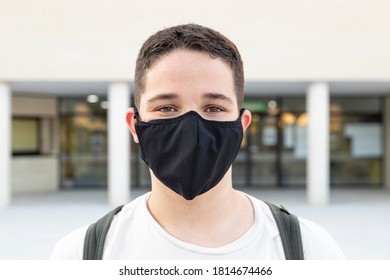 Close Up Of A Teenager Student With Protective Mask Standing Outside High School. New Normal