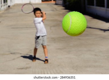 Close up tennis ball fly closer from boy hit
