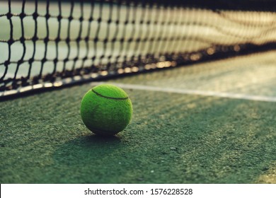 Close up tennis ball and net at court, sport wallpaper background, relaxation and lifestyle concept