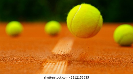 Close up of Tennis ball ping on clay court inside or outside white line - Powered by Shutterstock