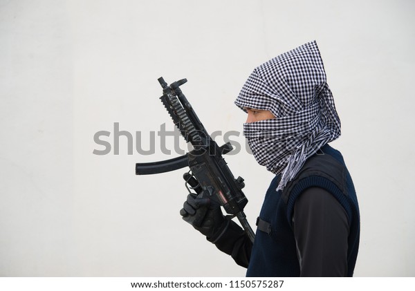Close up terrorist with gun on\
white background,Thailand people,A bad guy,He is no good\
man