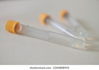 Close up of Test tubes containing cat serum lyiing on white background, India.