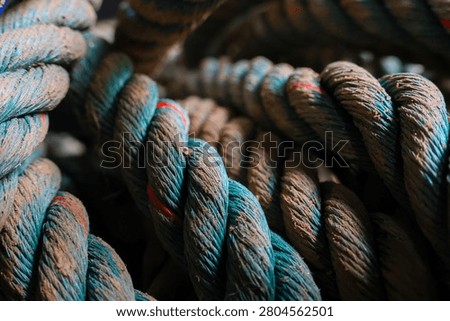Close up textured thick twisted blue brown rope fiber detail rugged strong durable nautical industrial outdoor weathered rough heavy cord equipment maritime strength pattern coil surface macro