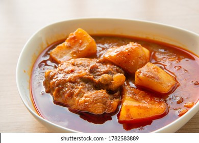 close up of Thai Chicken massaman curry - Thai chicken and potato curry in coconut milk and herb eat with white rice - Powered by Shutterstock