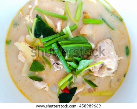 close up Thai Chicken Soup in Coconut Milk on wooden table