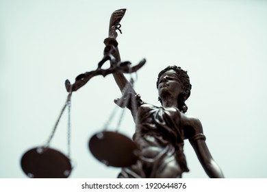 close up of Themis Statue with  Justice Scales on bright background.