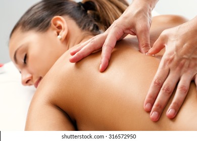 Close up of Therapist doing curative healing massage with thumbs on female back. - Shutterstock ID 316572950