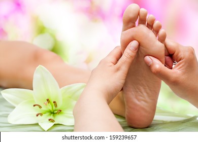 Close Up Of Therapist's Hands Massaging Female Foot.