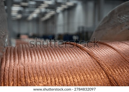 Close up of thick copper wire cable spool in industrial factory warehouse