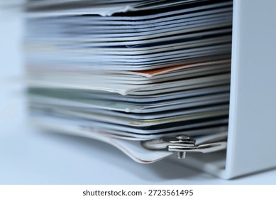Close up of a thick stack of various cards in a holder