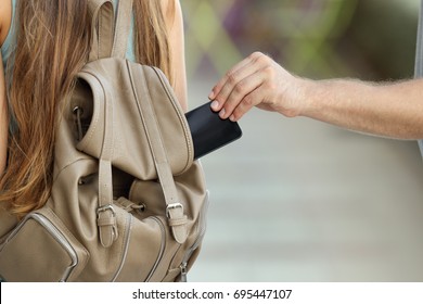 Close Up Of A Thief Hand Stealing A Phone From A Bag On The Street