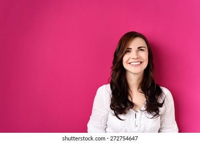 Close up Thoughtful Pretty Girl Looking Up with a Smile, Isolated on Pink Background with Copy Space.