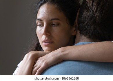 Close Up Thoughtful Young Woman Hugging Man, Looking In Distance, Thinking About Marriage Problems, Suspicious Doubting Wife Embracing Husband, Pondering Cheating In Relationship, Break Up