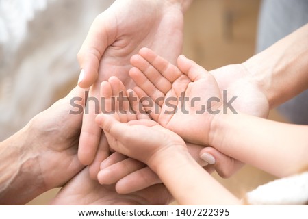Close up of three caucasian person stack their palms. Grandmother mother and granddaughter holding their hands together. Gesture sign of support and love, unity togetherness relative people concept