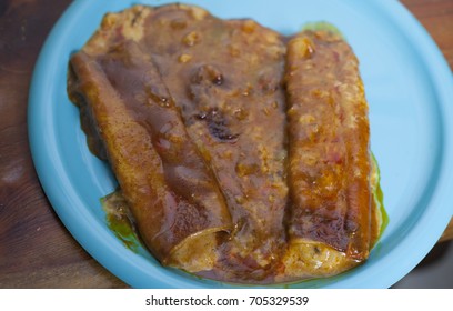 Close Up Of Three Cheese Enchiladas On A Pretty Blue Plate