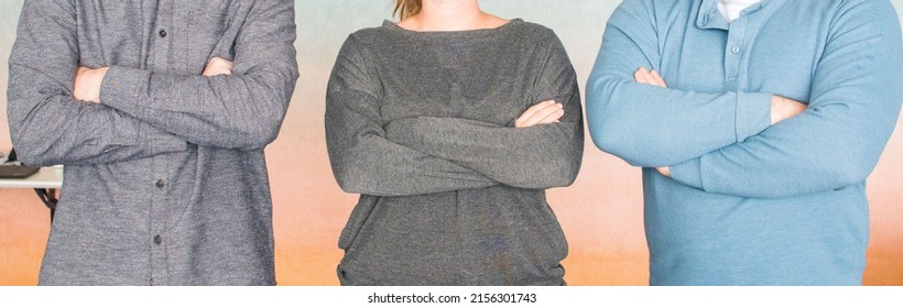 A Close Up Of Three People With Cross Folded Arms