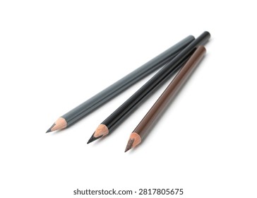 Close up of three sharpened pencils in gray black and brown tones arranged diagonally on a clean white surface