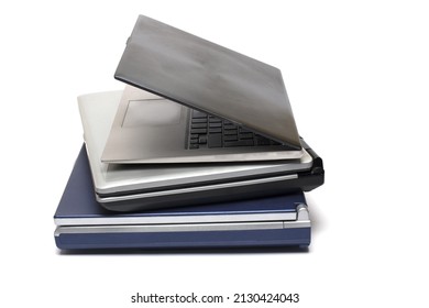 Close up of three stacked notebooks of different generations from old and heavy to modern and ultra light on white background concept development and evolution of computer technology