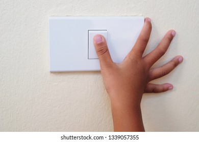 Close Up Thumb Finger’s Kid Is Turning On Or Turning Off The Light-switch.