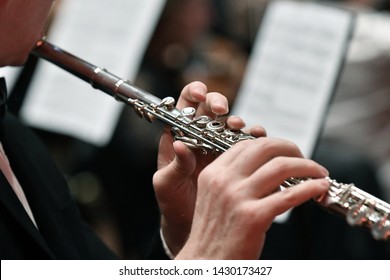 Close up tight shot of hand playing flute