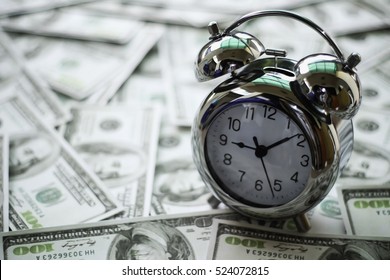 Close Up Of Time And Money With Green Bokeh Background ,Business Finance And Money Concept,Save Money For Prepare In The Future.time Is Money Concept