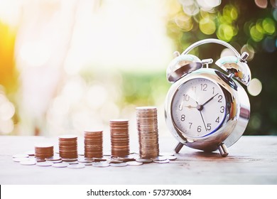 Close Up Of Time And Money With Green Bokeh Background ,Business Finance And Money Concept,Save Money For Prepare In The Future.time Is Money Concept