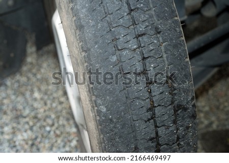 Close up tire that are worn down and have lost their edge grooves