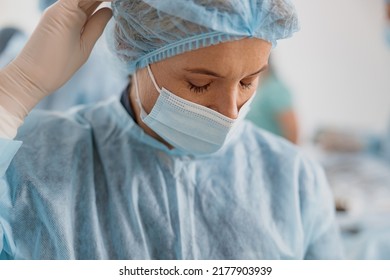 Close Up Of Tired Surgeon In Mask Standing In Operating Room After Major Surgery