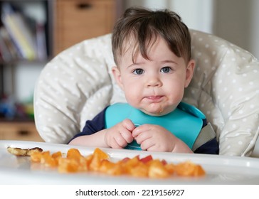 Close Up Of Toddler Eating Mandarins In His High Chair