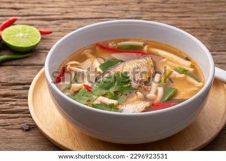 Close up Tom Yam canned mackerel fish in tomato sauce with Shimeji mushroom.Asian spicy soup