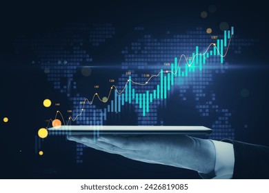 Close up of toned male hand holding mobile phone with growing forex chart on blurry blue background with map. Financial investment and economy concept