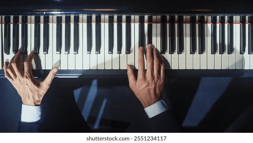 Close Up Top Down on Pianist Hands Playing a Mesmerizing Jazz Melody on a Grand Piano. Anonymous Artist is Focused on Creating Beautiful Instrumental Sonata as He Plays on Stage for the Audience - Powered by Shutterstock - Get 15% off with code: PIKWIZARD15
