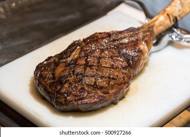 Close Up Top Down View On Single Barbecued Rib Tip  On Dark Background
