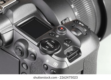 Close up top panel of professional Mirrorless Digital Camera, DSLR, show on camera mode command functional dial, function lock, light, Video record, multi function button, af-on and joystick. - Shutterstock ID 2262475023