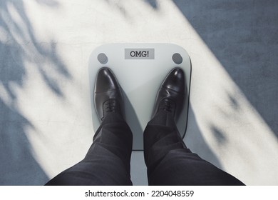 Close Up And Top View Of Business Man Feet On Scales Asking For Help. Lose Weight And Measuring Concept