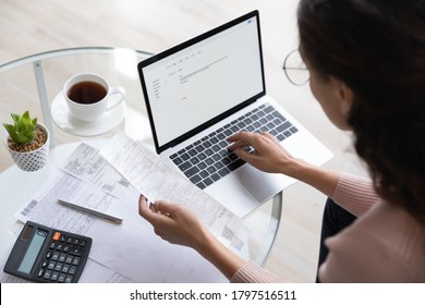 Close up top view of concentrated woman work on laptop manage family expenditures expenses using gadget, focused housewife busy calculating finances, plan budget on computer, pay bills or taxes online - Shutterstock ID 1797516511