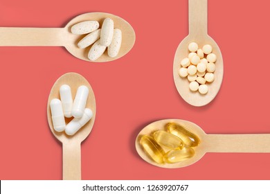 Close up top view of different healthy vitamin supplements on wooden spoons