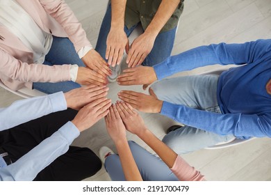 Close Up Top View Of Diverse Employees Sit In Circle Join Hands Palms Together Showing Unity. Multiracial People Engaged In Teambuilding Training. Office Diversity. Teamwork Concept.