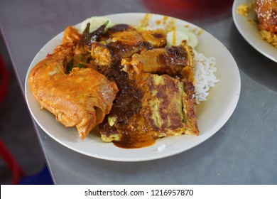 Close up or top view of famous Nasi Kandar in Penang, Malaysia. Rice with variaty dish on a plate. - Shutterstock ID 1216957870