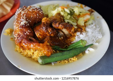 Close up or top view of famous Nasi Kandar in Penang, Malaysia. Rice with variaty dish on a plate. - Shutterstock ID 1216957876